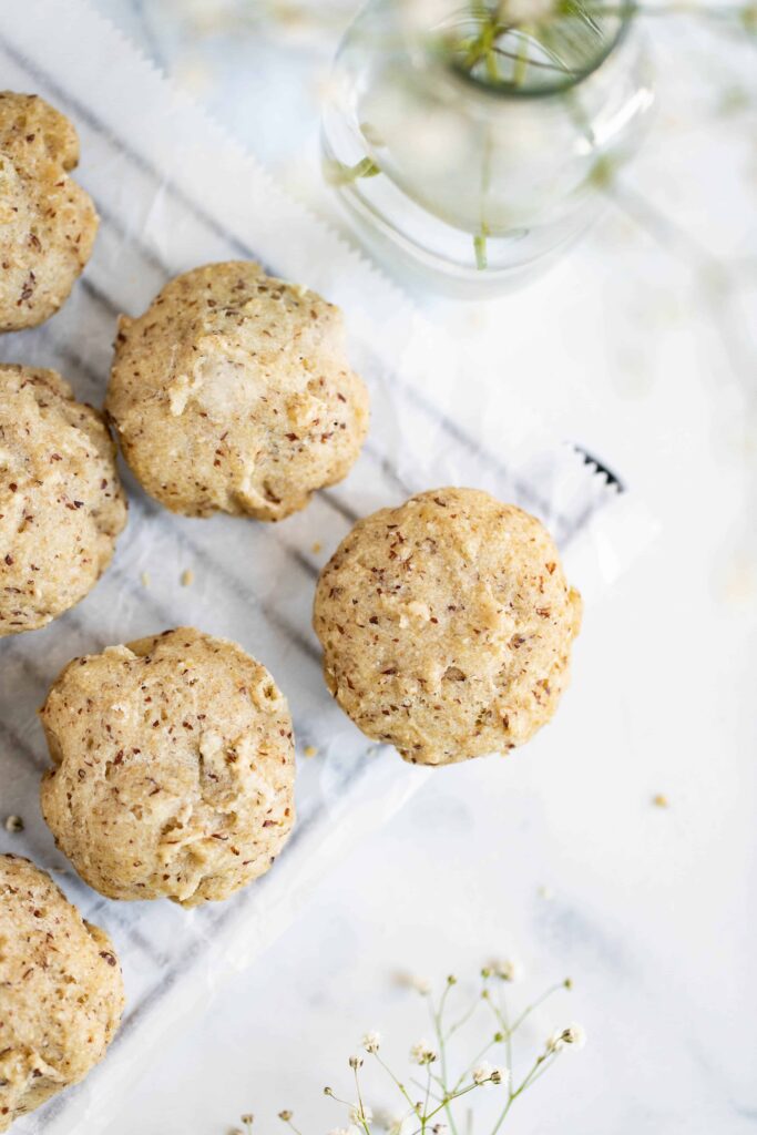 vegan grain-free rolls on cooling rack with flower vase next to it