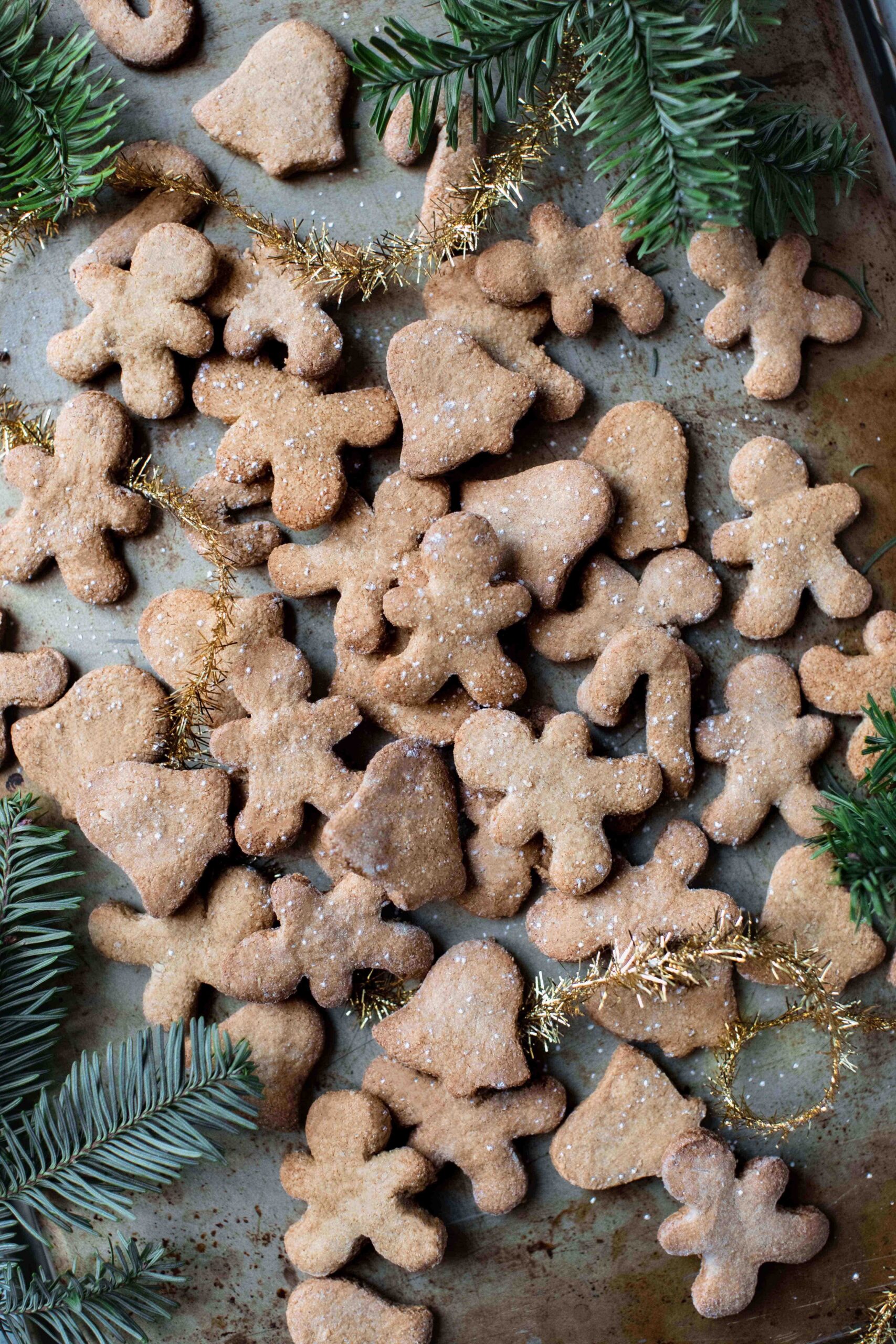 pile of Easy one-bowl gingerbread cookies in gingerbread man cut outs