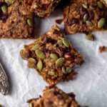 Easy One Bowl Vegan & Gluten-Free Pumpkin Oatmeal Bars on parchment paper with knife in corner