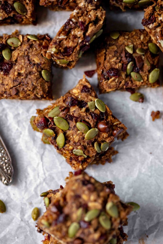 Easy One Bowl Vegan & Gluten-Free Pumpkin Oatmeal Bars on parchment paper with knife in corner