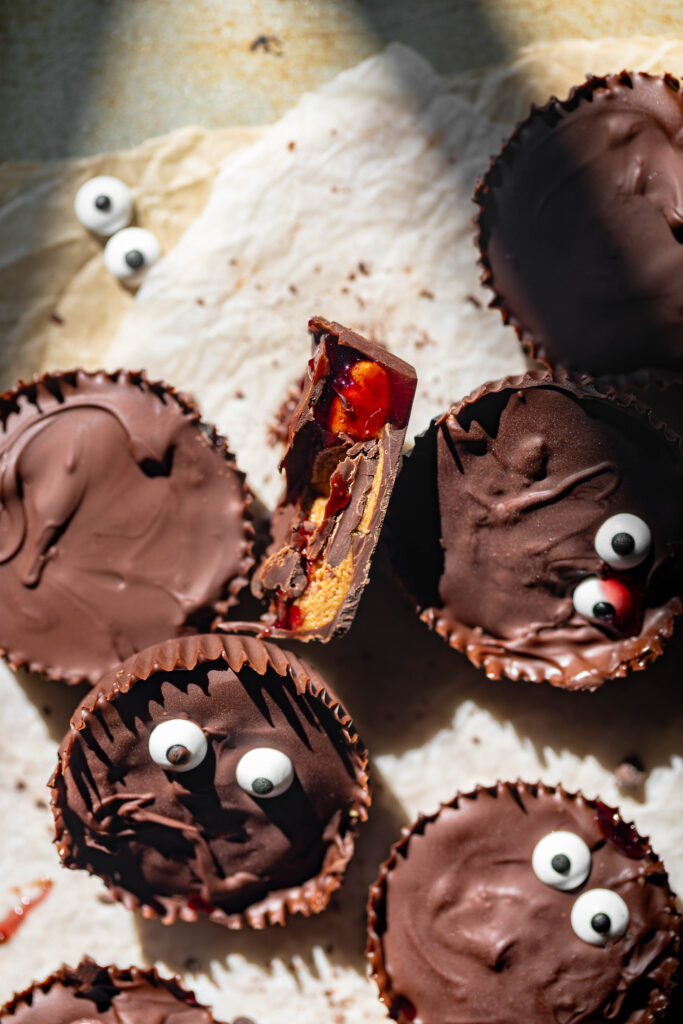 halloween themed monster peanut butter cups with jam filling and candy eyes