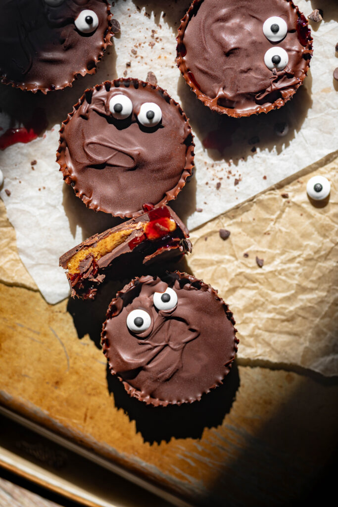 halloween themed monster peanut butter cups with jam filling and candy eyes