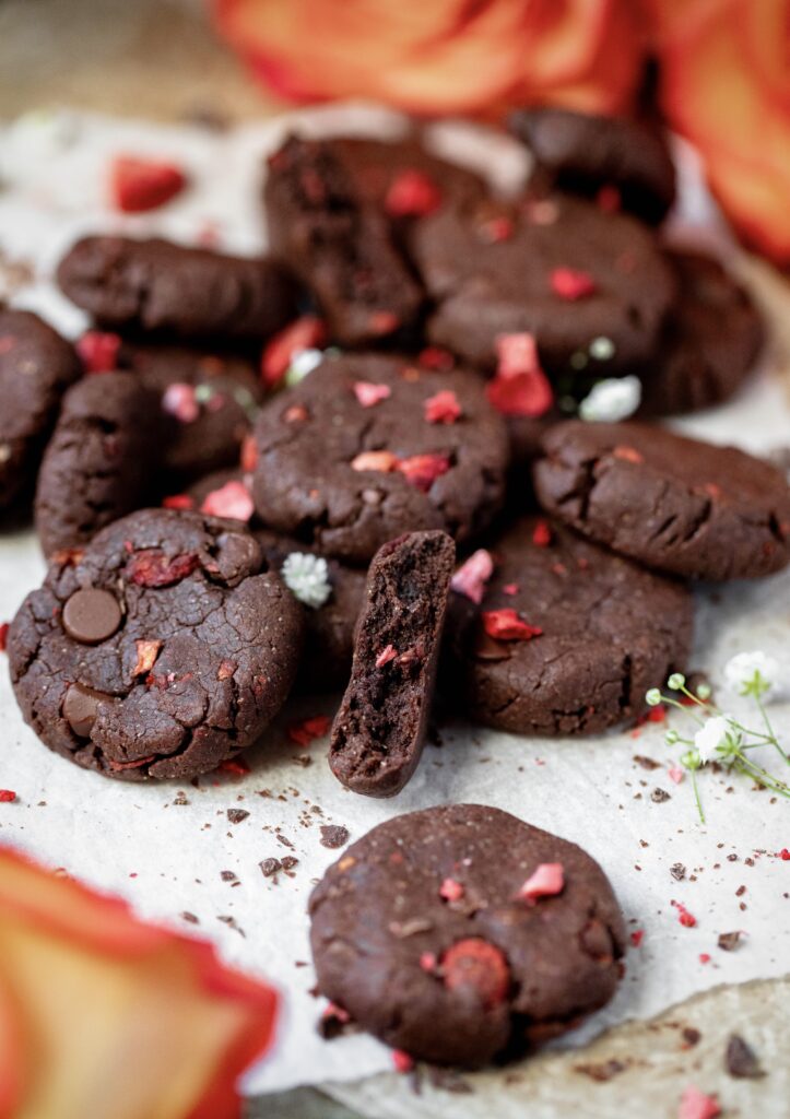 Healthier Chocolate Strawberry Cookies in a pile with some roses around